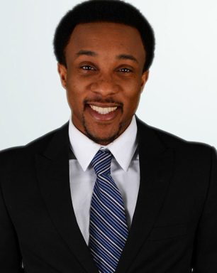 a man in a suit and tie smiling.